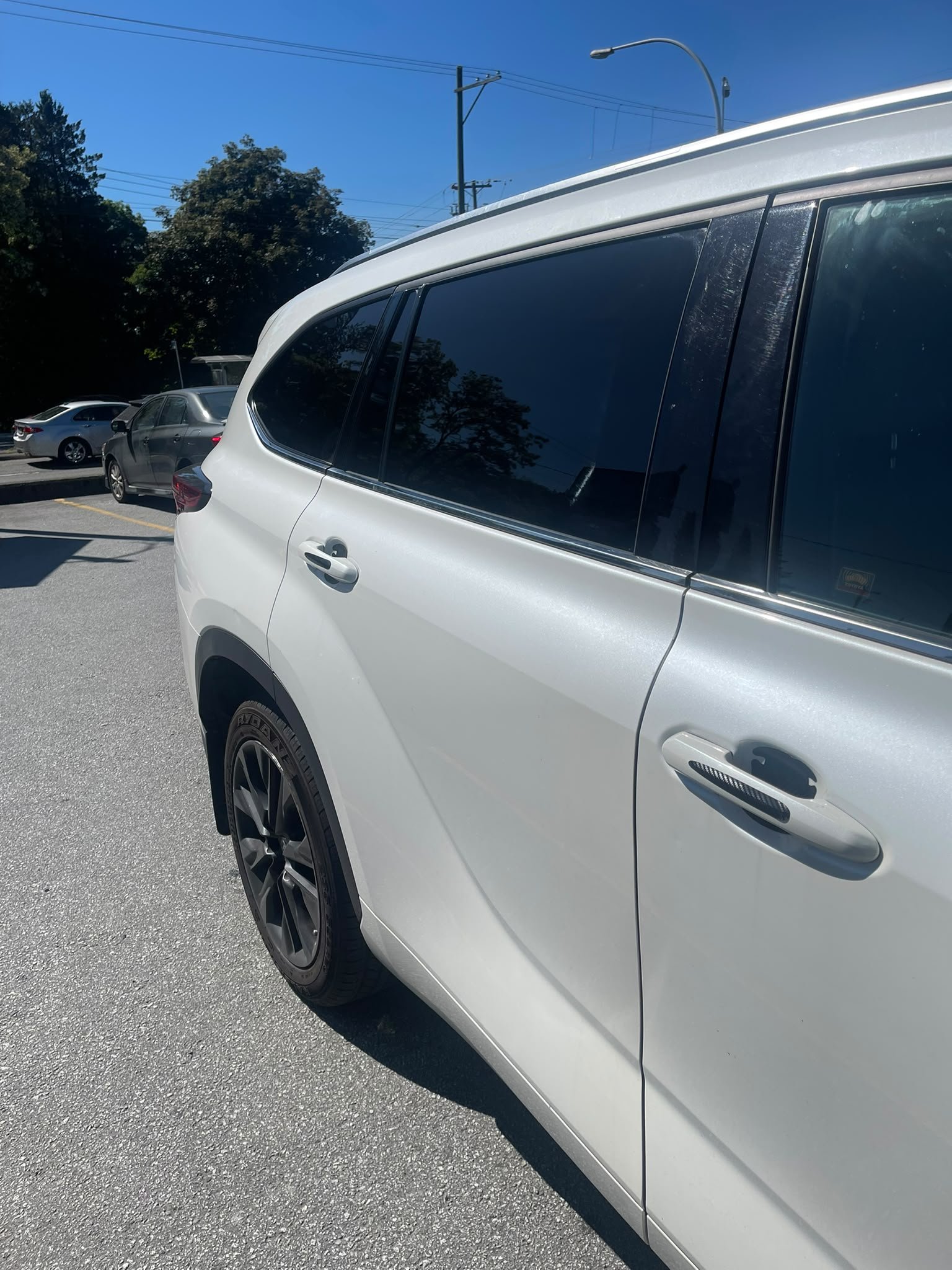 White SUV with dark rear window film